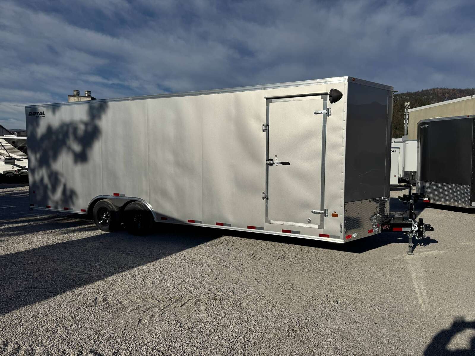 Photo of 2026 Royal Cargo 8.5x24 V Nose Car Hauler Cargo / Enclosed Trailer 11,400lb GVW Silver Ramp Door Extra Height