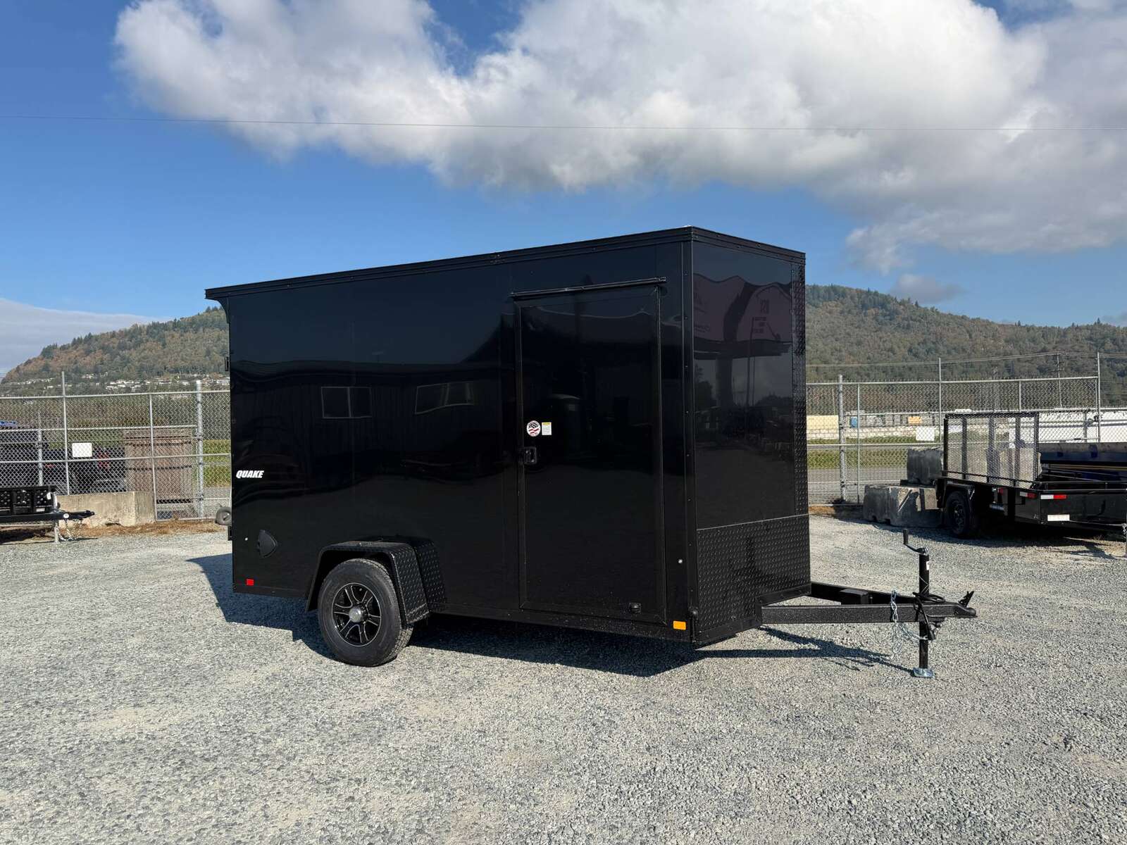 Photo of 2027 Impact Quake 7x12 V Nose Cargo / Enclosed Trailer / Black Polycor Exterior / 5000lb GVW Brake Axle w/ Ramp Door