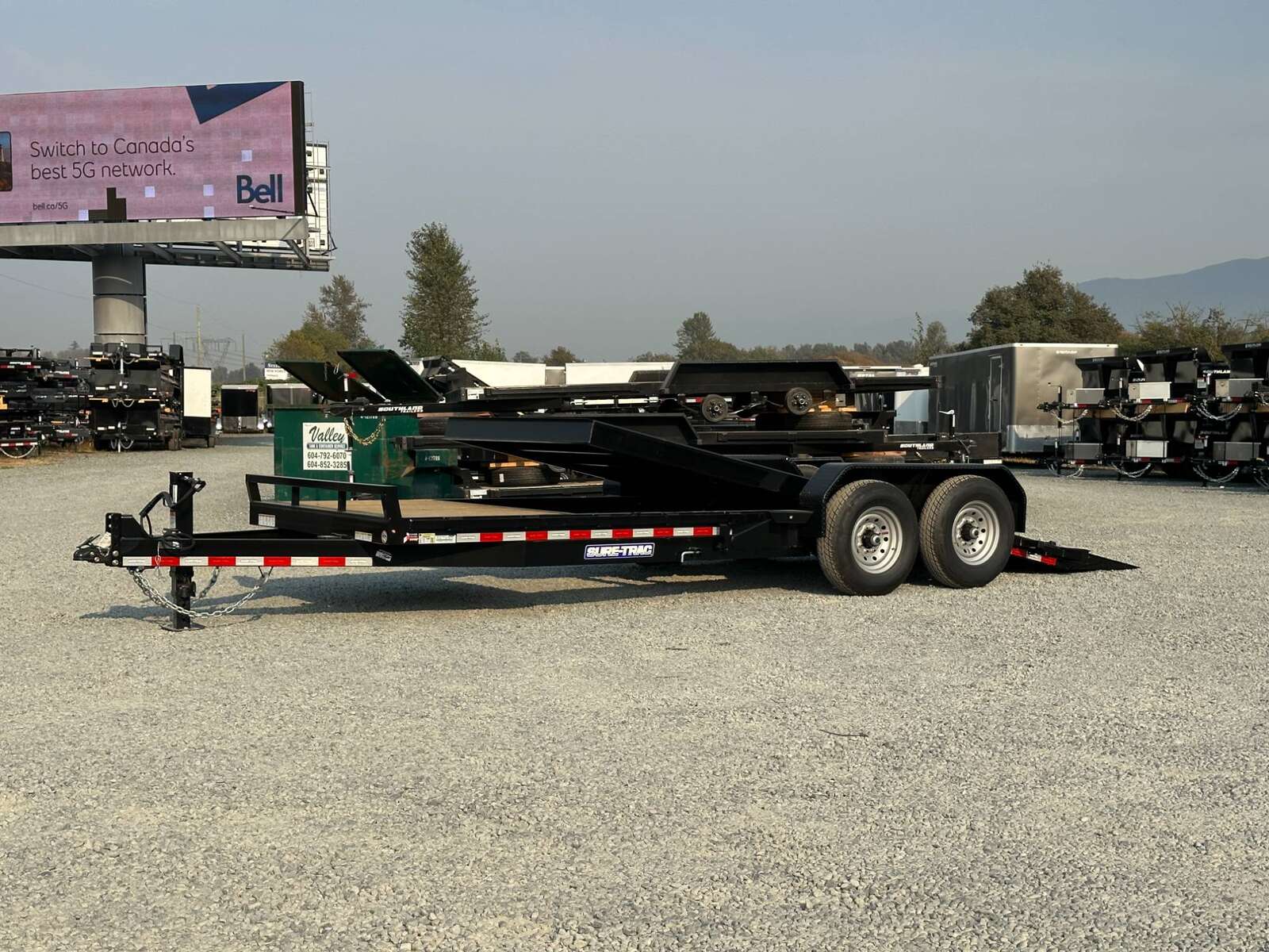 Photo of 2025 Suretrac 7x16+4 HD Tilt Deck Equipment Trailer w/ 4ft Stationary Section 14,000lb GVW